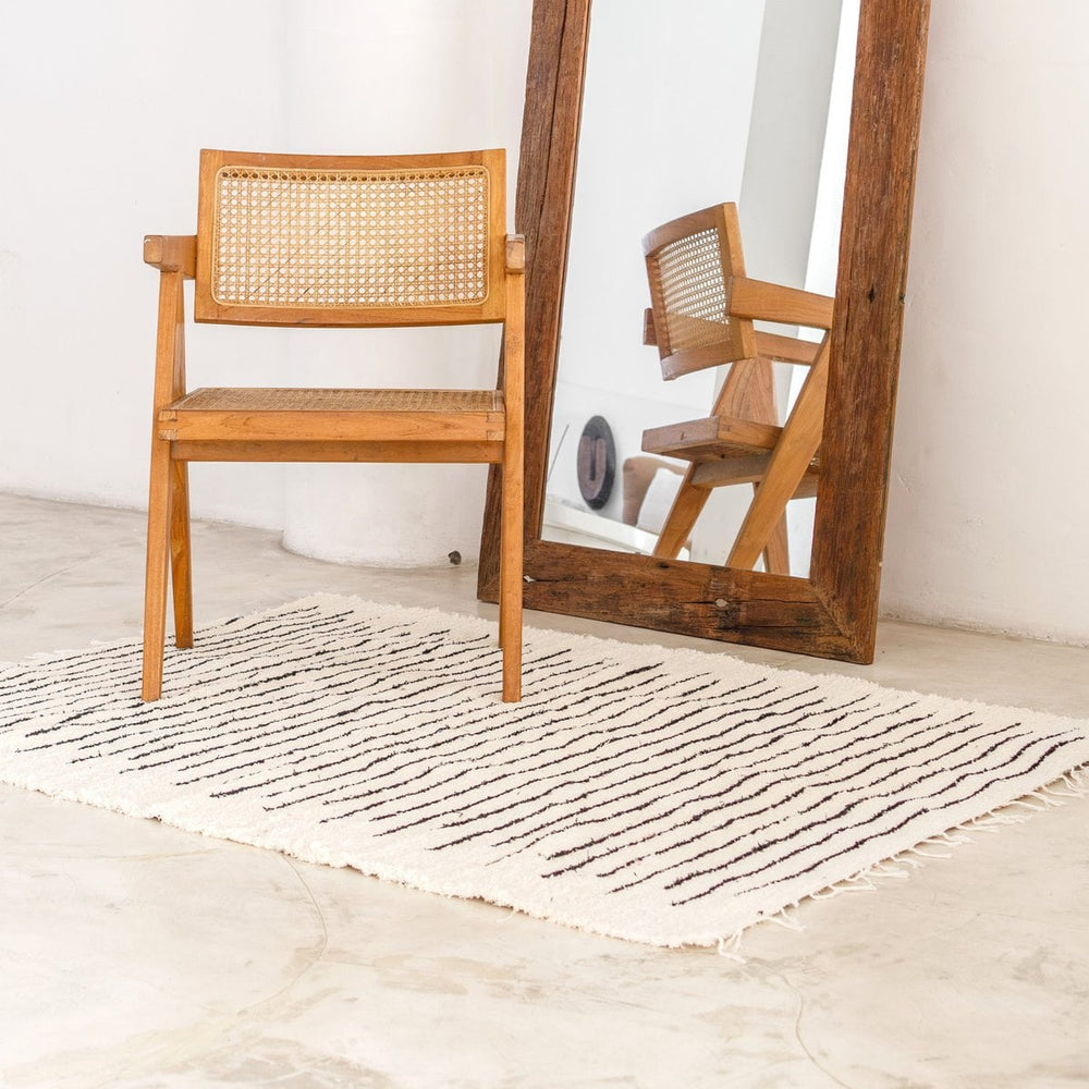 White handwoven cotton rug with black stripes