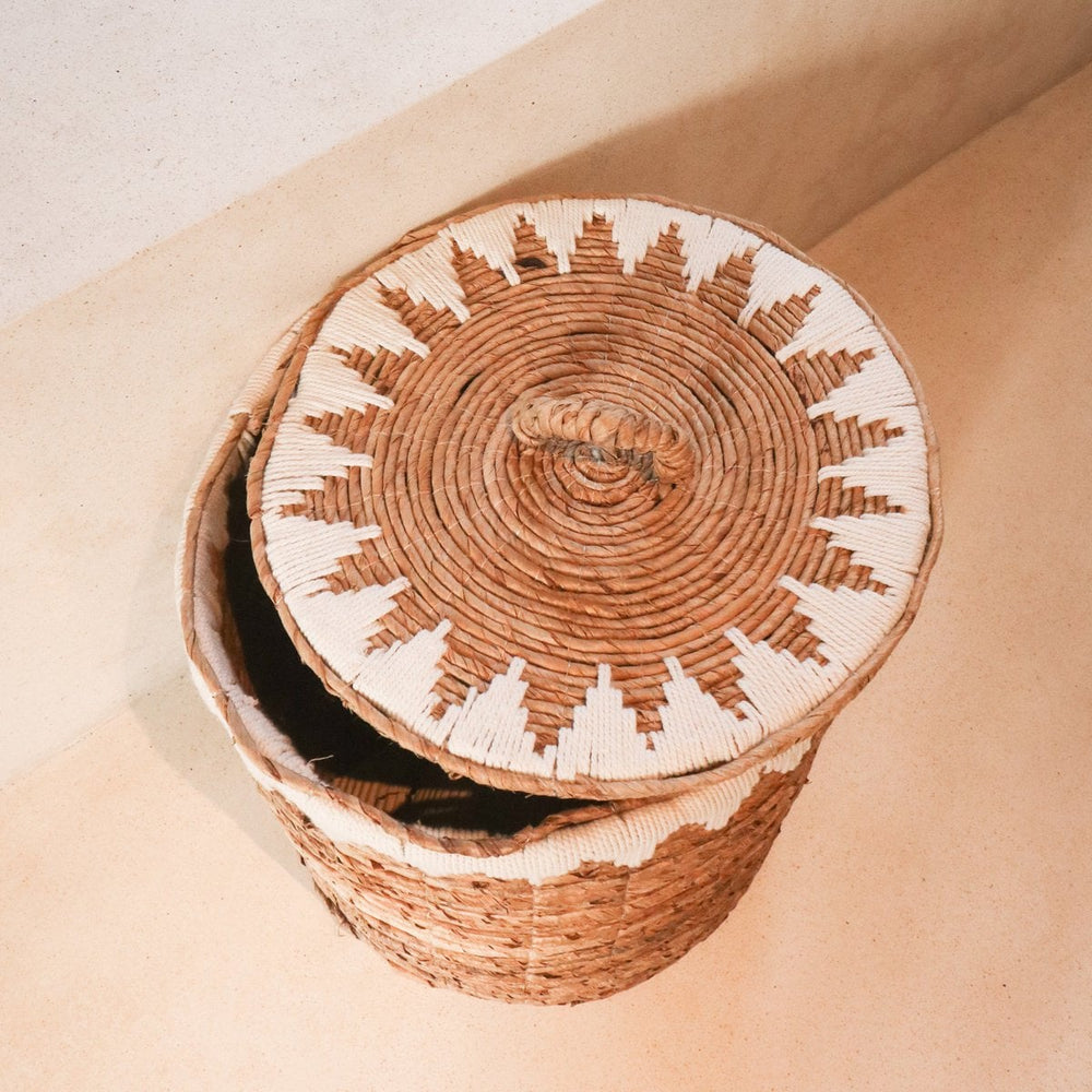 Brown woven banana fibre laundry basket with lid and white cotton macrame pattern