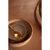 White stoneware cereal bowl with cinnamon-toned drip glaze