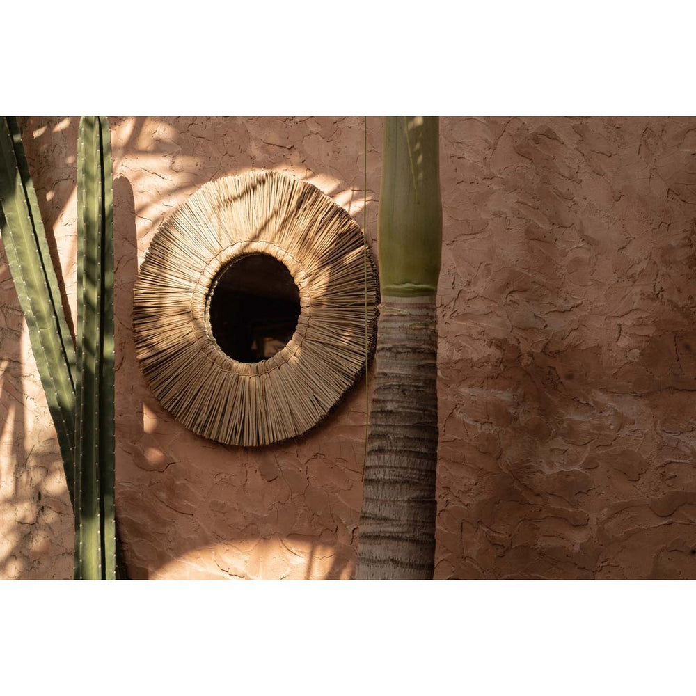 Beige round grass-framed mirror