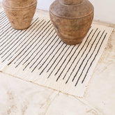 White handwoven cotton rug with black stripes
