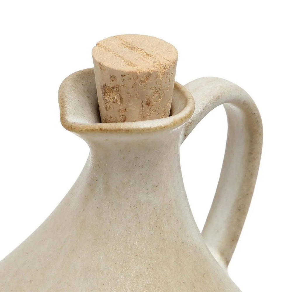 Beige ceramic bottle with cork stopper on a white background