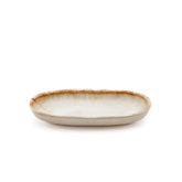 Ceramic dish with brown rim on a white background
