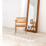 White handwoven cotton rug with black stripes