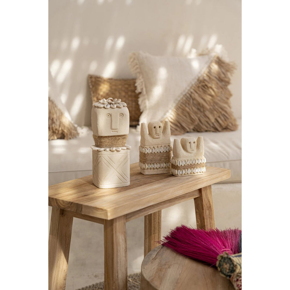 Sandstone statue with cowrie shells and jute wrap