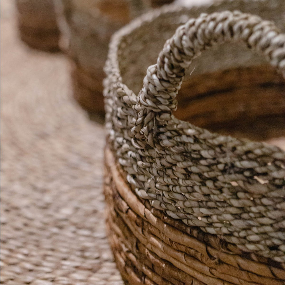 Beige and brown woven seagrass and banana fibre storage basket