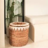 Brown woven banana fibre laundry basket with lid and white cotton macrame pattern