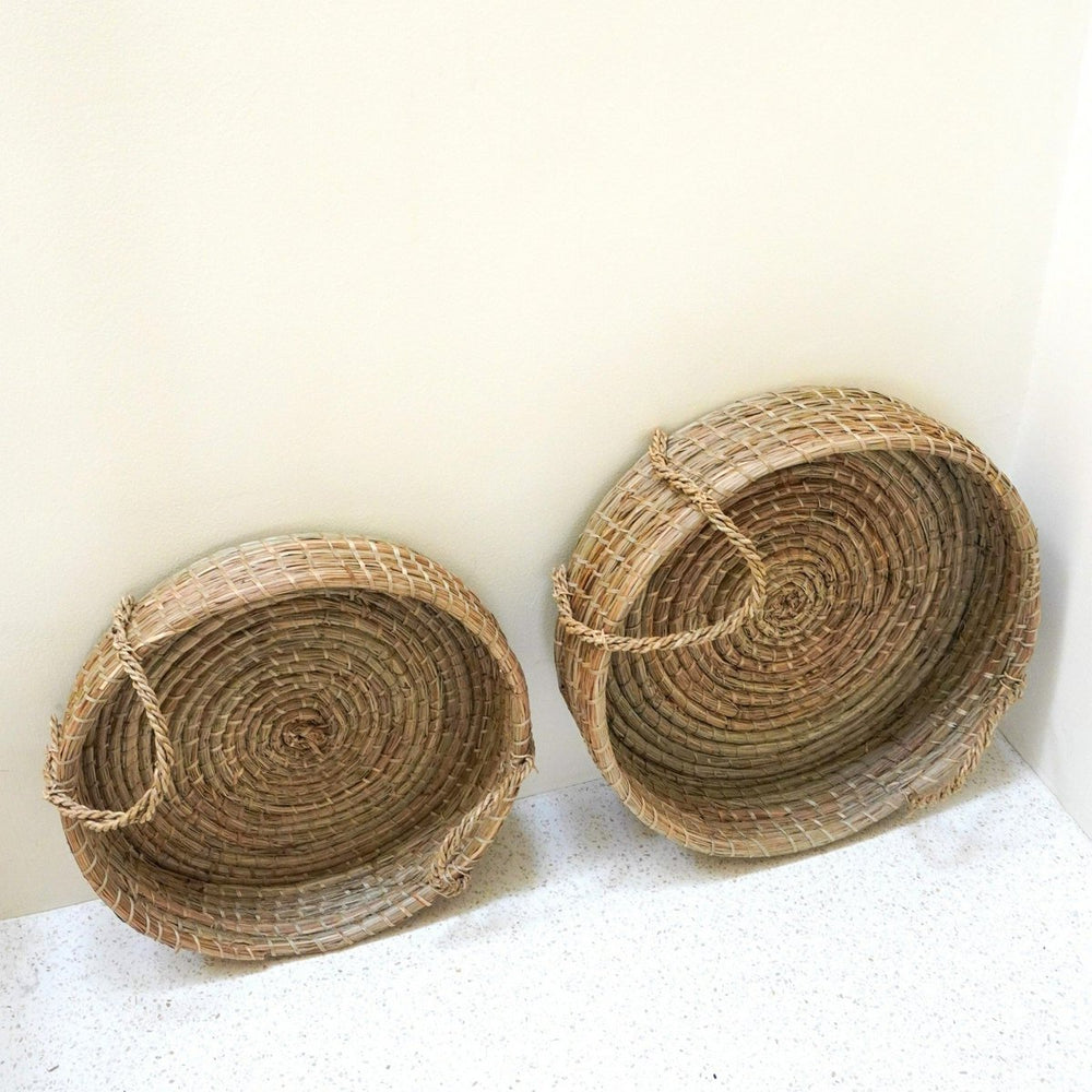 Beige woven seagrass round serving tray with handles