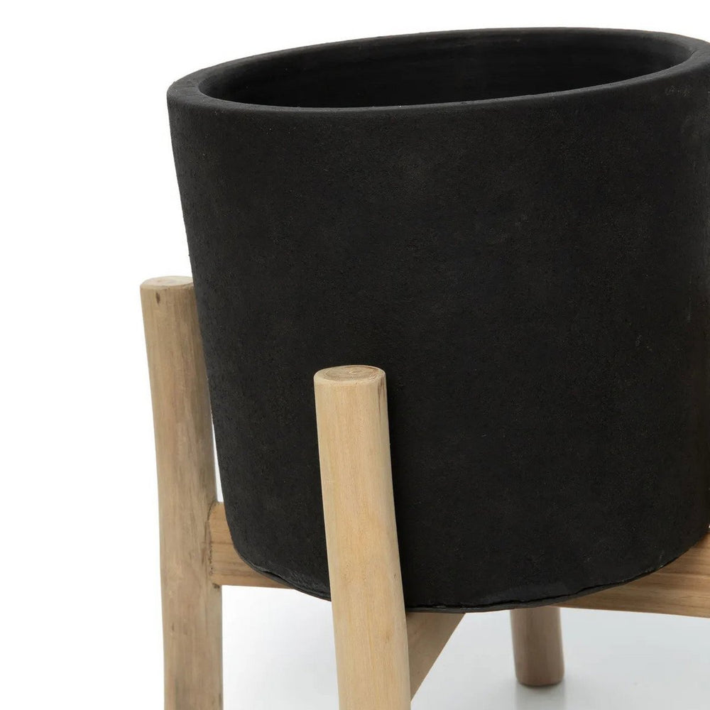 Black terracotta planter on teak branch stand