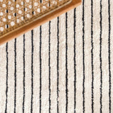 White handwoven cotton rug with black stripes