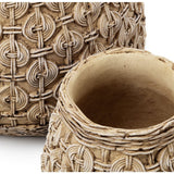 Close-up of a textured ceramic pot with intricate patterns on a white background