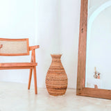 Beige and brown handwoven banana fiber vase with raffia accents