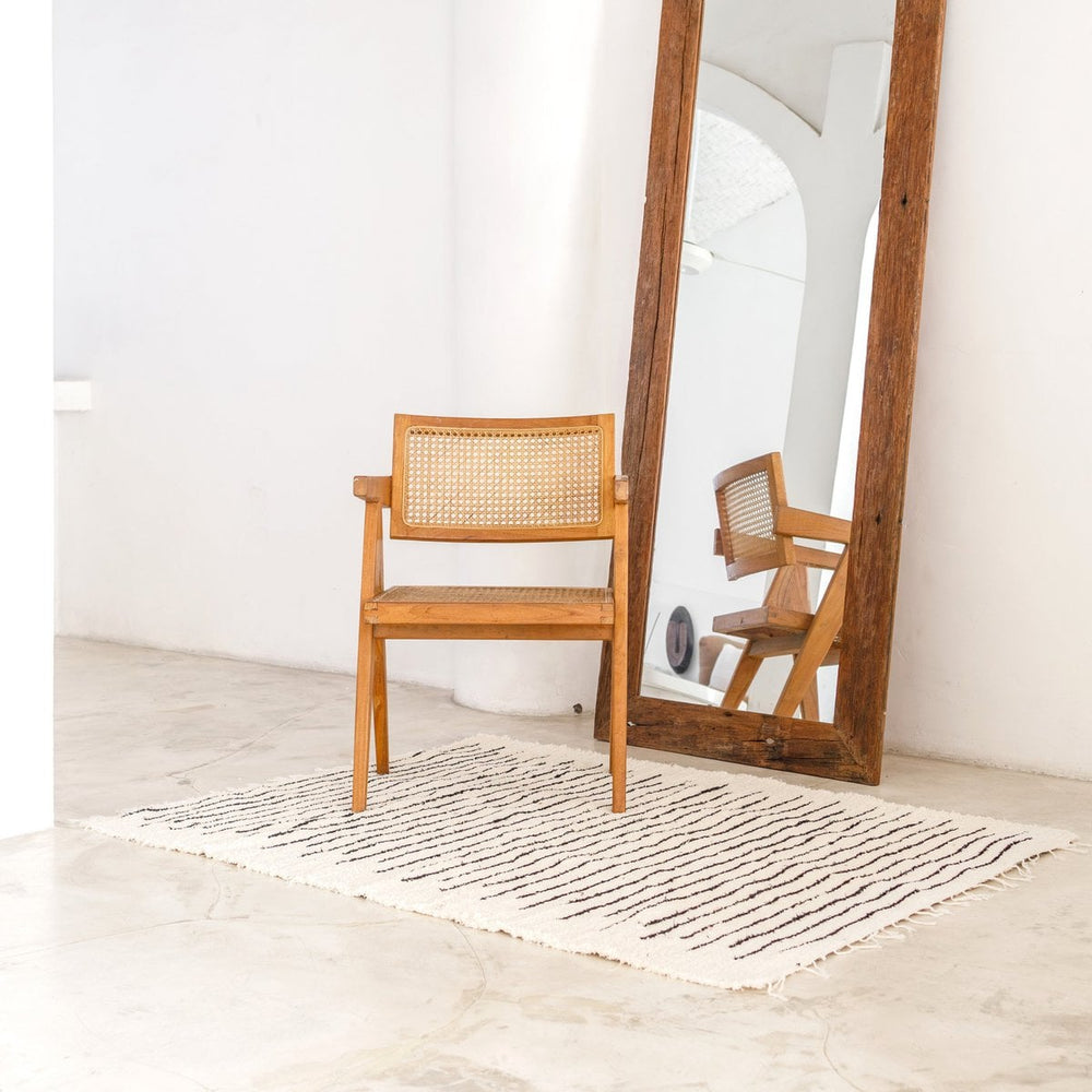 White handwoven cotton rug with black stripes