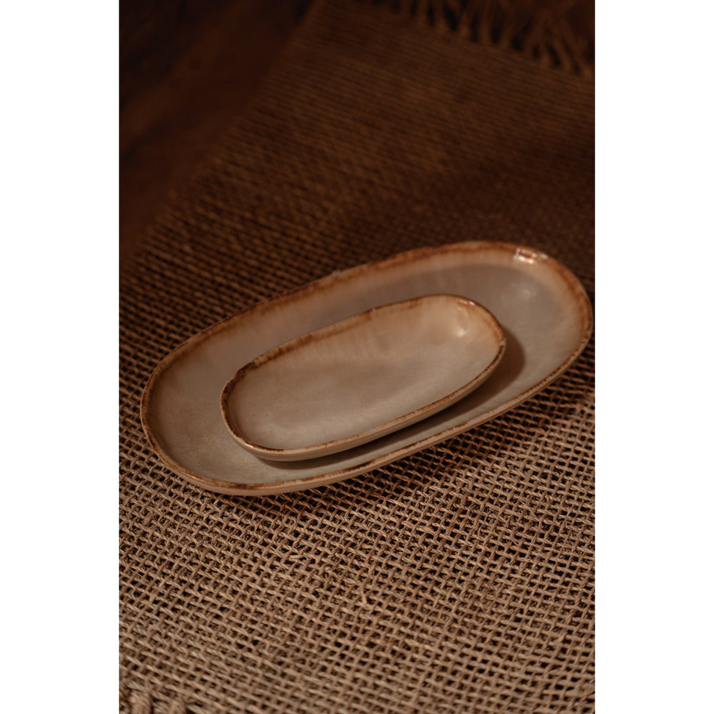 Two ceramic plates on a textured brown surface
